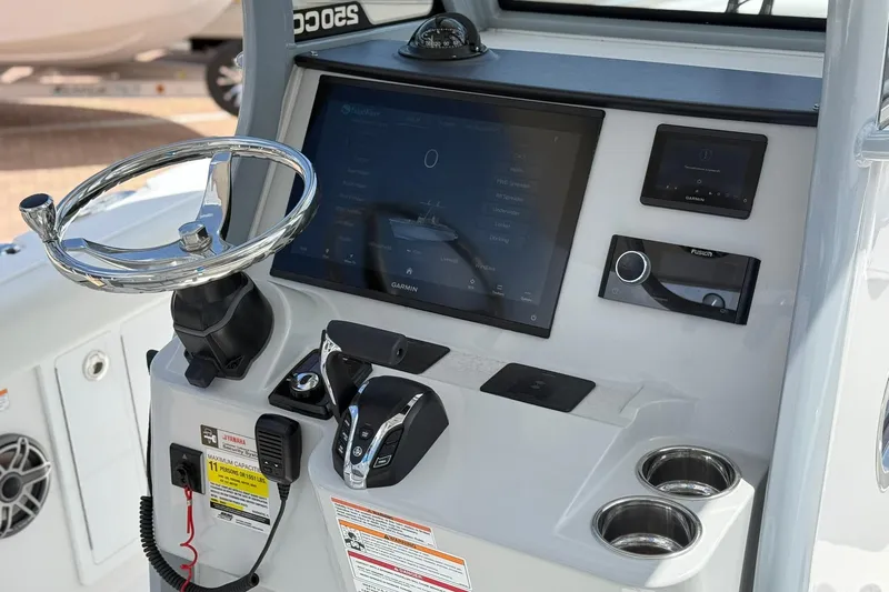 Slide: The Image of 2026 Edgewater 250CC boat dashboard with steering wheel and digital controls. - 12