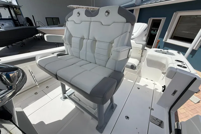 Slide: The Image of 2026 Edgewater 250CC boat interior with cushioned seating and modern design. - 14