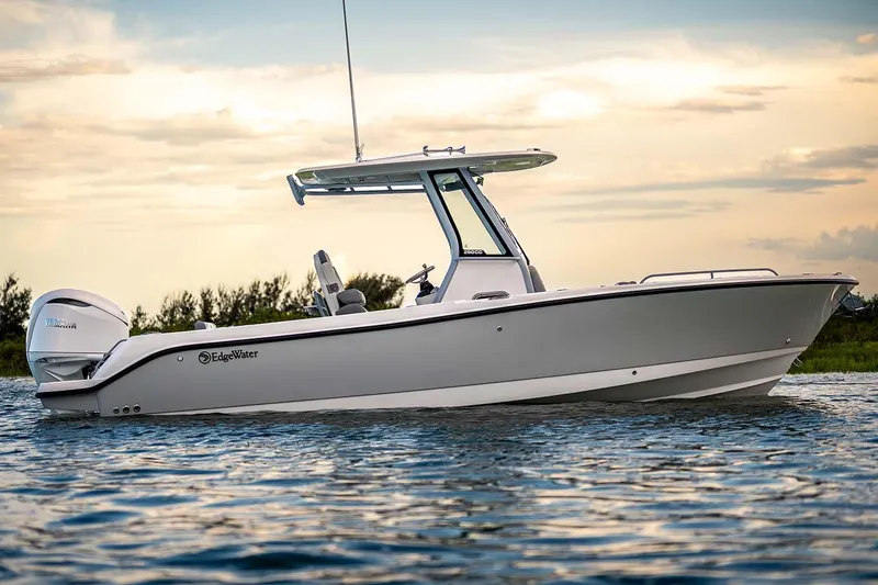 Slide: The Image of Manufacturer Provided Image: 2026 Edgewater 250CC boat on water at sunset, showcasing sleek design and Yamaha engine. - 18