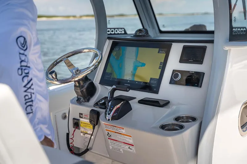 Slide: The Image of Manufacturer Provided Image: 2026 Edgewater 250CC boat dashboard with navigation system and controls. - 22