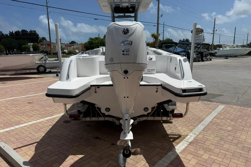 Slide: The Image of 2026 Edgewater 250CC boat with powerful outboard motor in a sunny marina. - 5