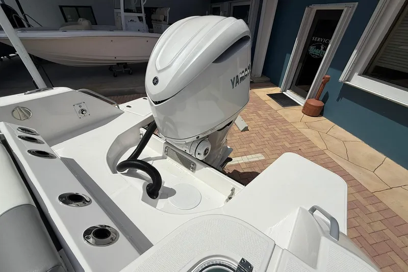 Slide: The Image of 2026 Edgewater 250CC boat with Yamaha outboard motor, docked near service area. - 6