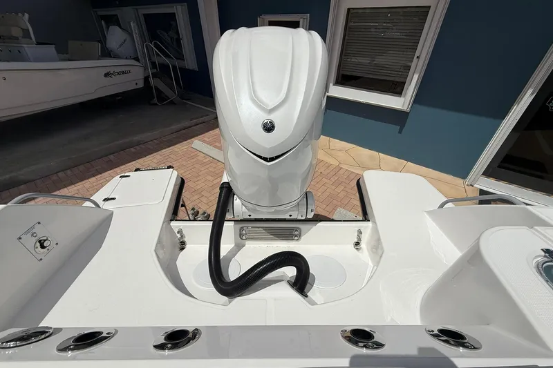 Slide: The Image of Edgewater 250CC 2026 boat with powerful outboard motor, docked near blue building. - 7