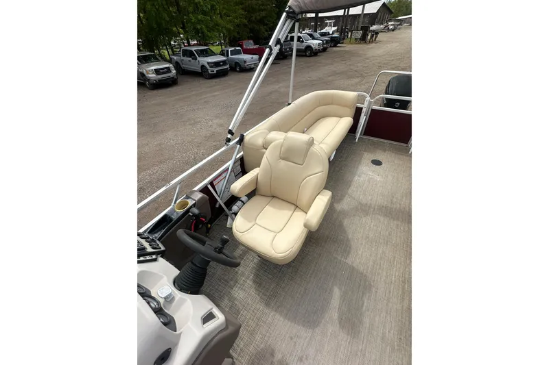Slide: The Image of 2018 Princecraft Vectra 23 XT pontoon boat interior with beige seating and steering console. - 15