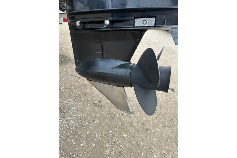 Slide: The Image of Close-up of a 2018 Princecraft Vectra 23 XT boat propeller on a gravel surface. - 26