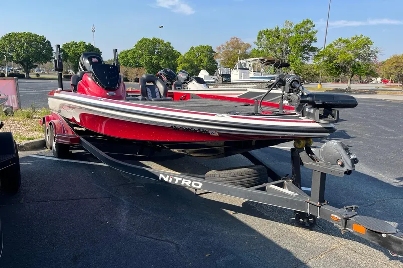 Slide: The Image of 2018 Nitro Z21 boat on trailer in parking lot, sunny day. - 1