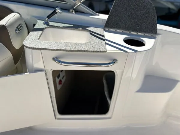 Slide: The Image of 2014 Chaparral 244 Sunesta boat kitchenette with sink and storage. - 26