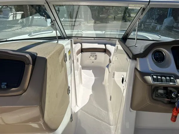 Slide: The Image of Interior of a 2014 Chaparral 244 Sunesta boat, featuring helm and seating area. - 37