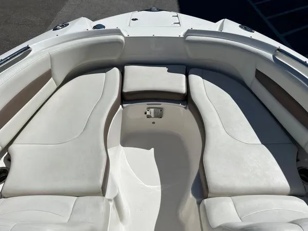 Slide: The Image of Interior of 2014 Chaparral 244 Sunesta with white cushioned seating. - 39