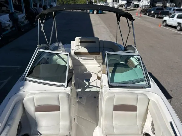 Slide: The Image of 2014 Chaparral 244 Sunesta boat with open cockpit and Bimini top. - 44