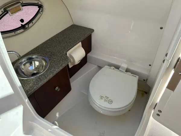 Slide: The Image of 2014 Chaparral 244 Sunesta interior with toilet and sink. - 48