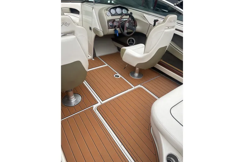 Slide: The Image of Interior of 2007 Sea Ray 220 Select boat with tan flooring and white seating. - 10