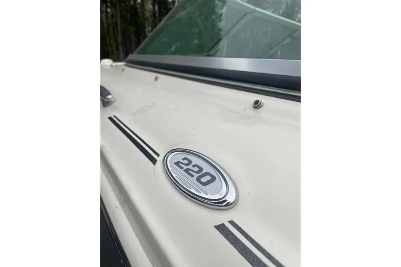 Slide: The Image of Close-up of a 2007 Sea Ray 220 Select boat emblem and windshield. - 12