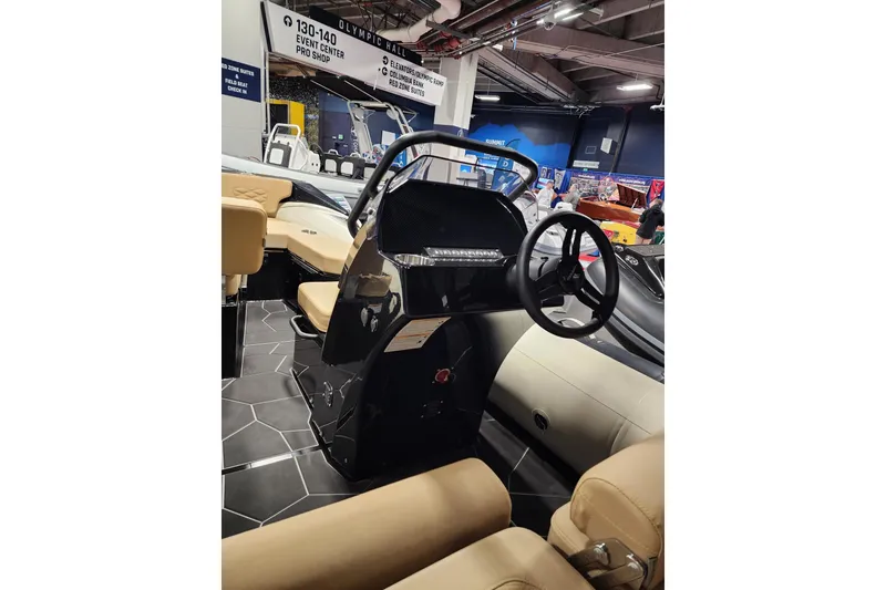 Slide: The Image of 2026 Highfield Sport 520 boat interior with steering wheel and seating at an event. - 11