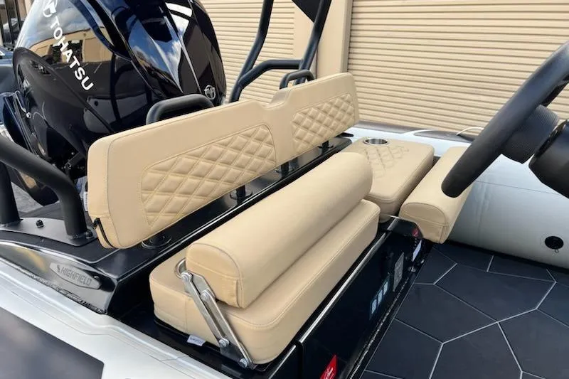Slide: The Image of 2026 Highfield Sport 520 boat interior with beige seating and Tohatsu engine. - 13