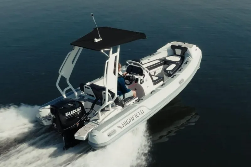 Slide: The Image of Manufacturer Provided Image: 2025 Highfield Sport 520 boat cruising on water with Suzuki outboard motor. - 15