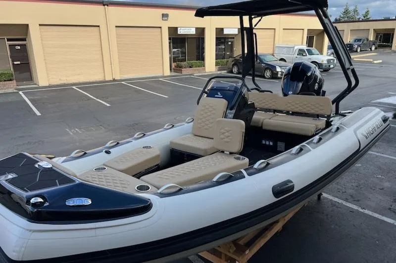 Slide: The Image of 2026 Highfield Sport 520 inflatable boat in a parking lot, showcasing beige seating and sleek design. - 4