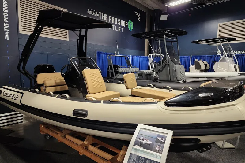 Slide: The Image of 2026 Highfield Sport 520 boat displayed indoors with tan seating and black accents. - 7