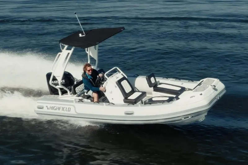 Slide: The Image of Manufacturer Provided Image: 2025 Highfield Sport 520 boat cruising on open water, featuring sleek design and Suzuki engine. - 9