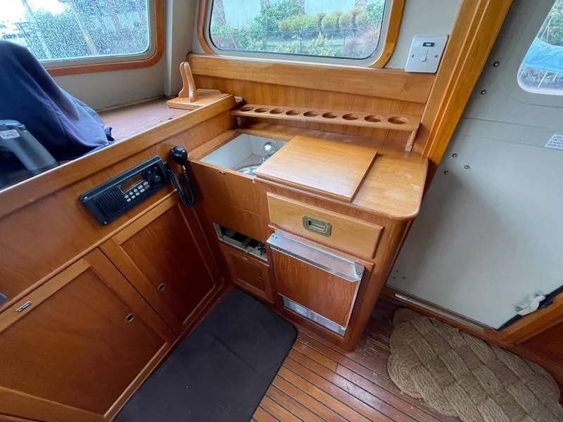 Slide: The Image of Interior of 1972 Grand Banks Alaskan 55 yacht with wooden cabinetry and radio equipment. - 12