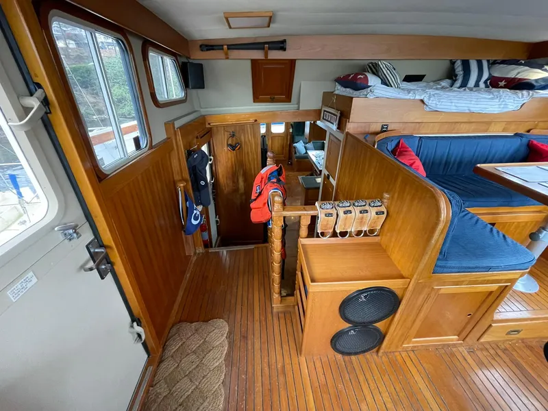 Slide: The Image of Interior of 1972 Grand Banks Alaskan 55 yacht with wood paneling and cozy seating area. - 13