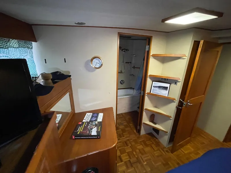 Slide: The Image of Interior of 1972 Grand Banks Alaskan 55 yacht with wooden furnishings and bathroom view. - 22