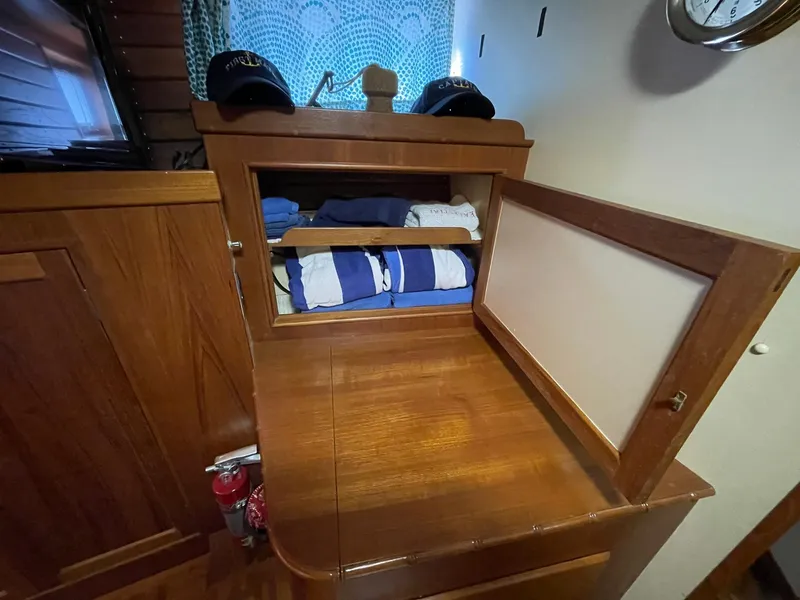 Slide: The Image of Wooden cabinet with folded clothes inside, aboard a 1972 Grand Banks Alaskan 55 yacht. - 23