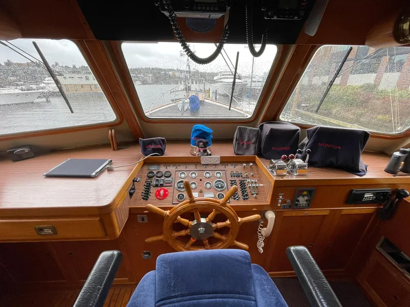 Slide: The Image of Helm of 1972 Grand Banks Alaskan 55 yacht with wooden wheel and navigation instruments. - 4