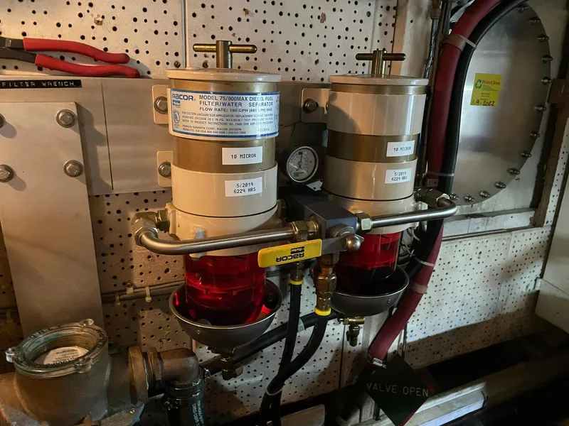 Slide: The Image of Engine room of 1972 Grand Banks Alaskan 55 with fuel filters and valves. - 41