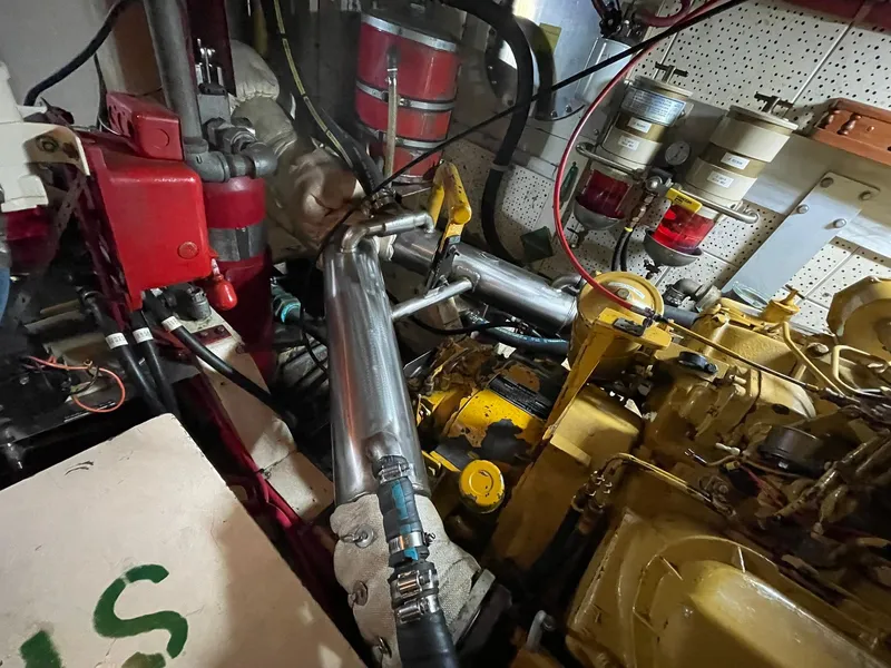Slide: The Image of Engine room of a 1972 Grand Banks Alaskan 55 yacht, showcasing mechanical components and piping. - 43