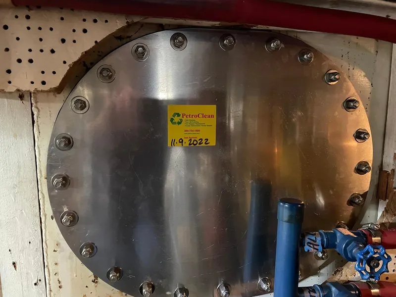 Slide: The Image of Stainless steel tank cover on 1972 Grand Banks Alaskan 55 boat, labeled "PetroClean" with date. - 48