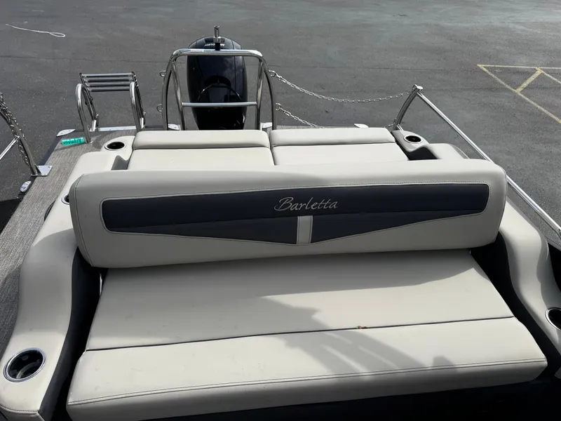 Slide: The Image of Rear view of a 2022 Barletta C22UC pontoon boat with beige seating. - 15