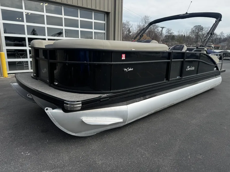 Slide: The Image of 2022 Barletta C22UC pontoon boat parked outside a building. - 4