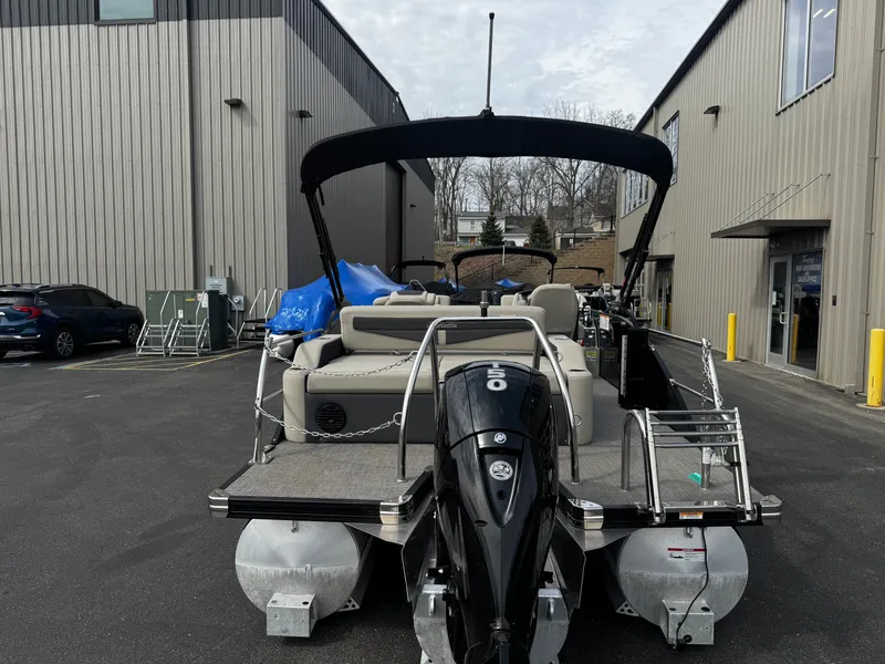 Slide: The Image of 2022 Barletta C22UC pontoon boat parked outside warehouse. - 6