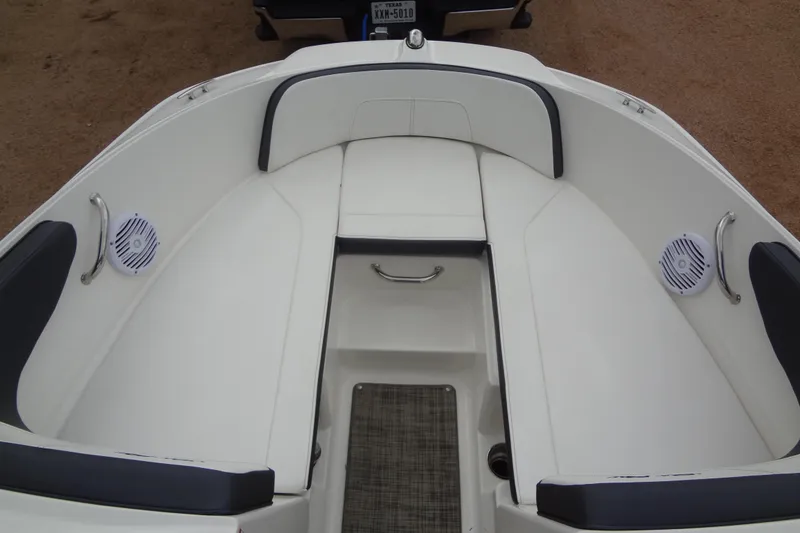 Slide: The Image of 2018 Sea Ray SPX 210 boat interior with white seating and speakers. - 10