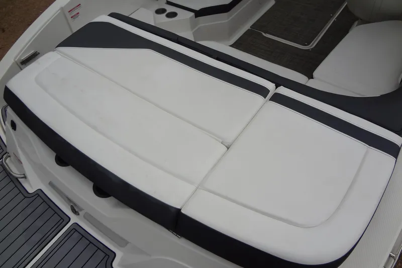 Slide: The Image of 2018 Sea Ray SPX 210 boat seating area with white and black upholstery. - 15