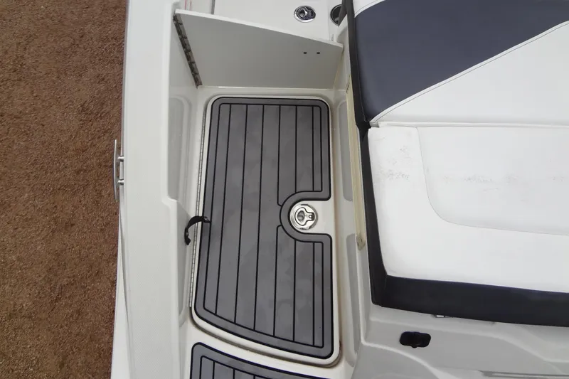Slide: The Image of 2018 Sea Ray SPX 210 boat deck with storage compartment and seating. - 18