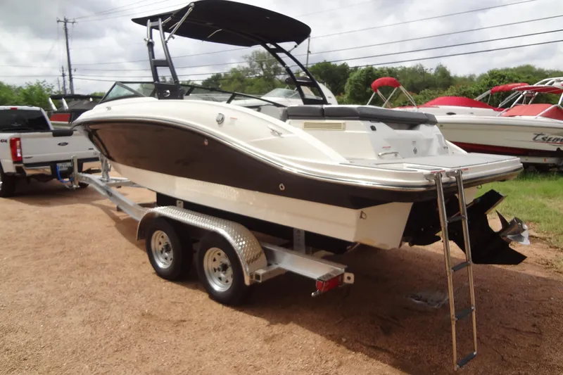 Slide: The Image of 2018 Sea Ray SPX 210 boat on trailer, parked outdoors, ready for transport. - 2