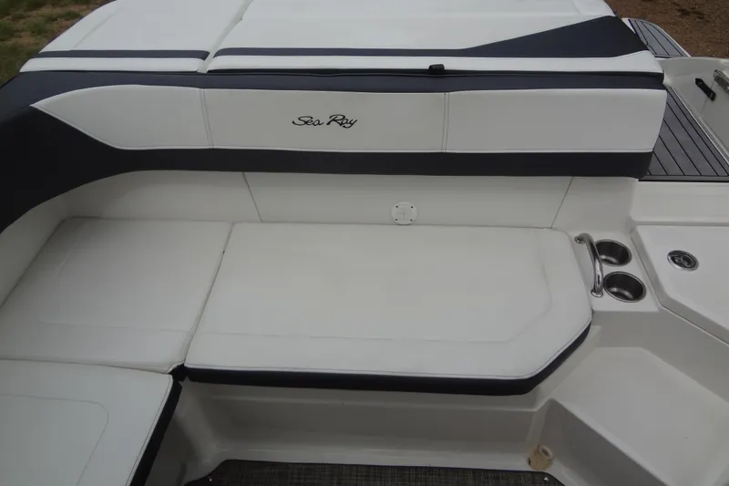 Slide: The Image of 2018 Sea Ray SPX 210 boat interior seating with cup holders and sleek design. - 20