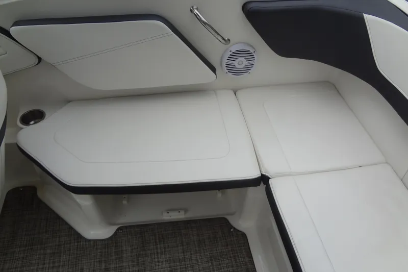 Slide: The Image of 2018 Sea Ray SPX 210 boat interior seating with white cushions and speaker. - 21