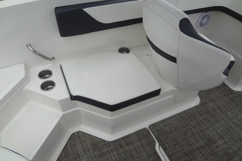 Slide: The Image of Interior seating of a 2018 Sea Ray SPX 210 boat with cup holders and modern design. - 22