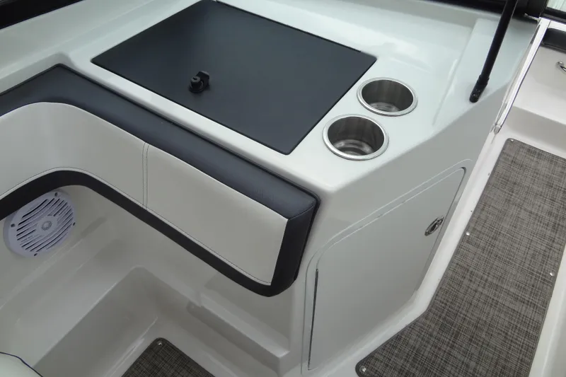 Slide: The Image of 2018 Sea Ray SPX 210 boat interior with cup holders and speaker. - 23