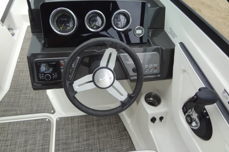 Slide: The Image of 2018 Sea Ray SPX 210 boat dashboard with steering wheel and control panel. - 26