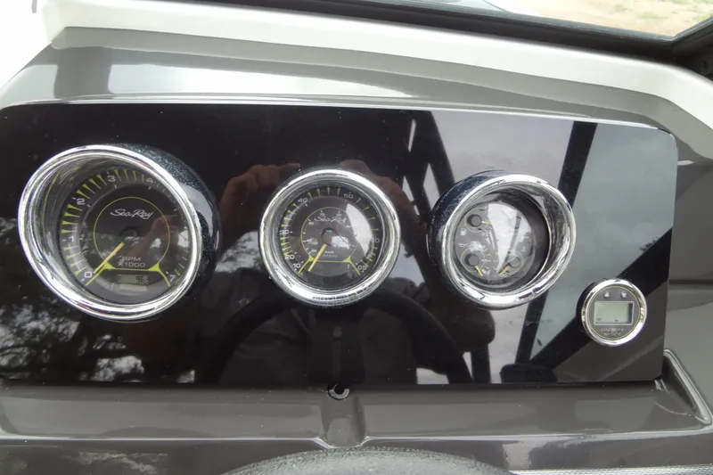 Slide: The Image of Dashboard of a 2018 Sea Ray SPX 210 boat with gauges and controls. - 27