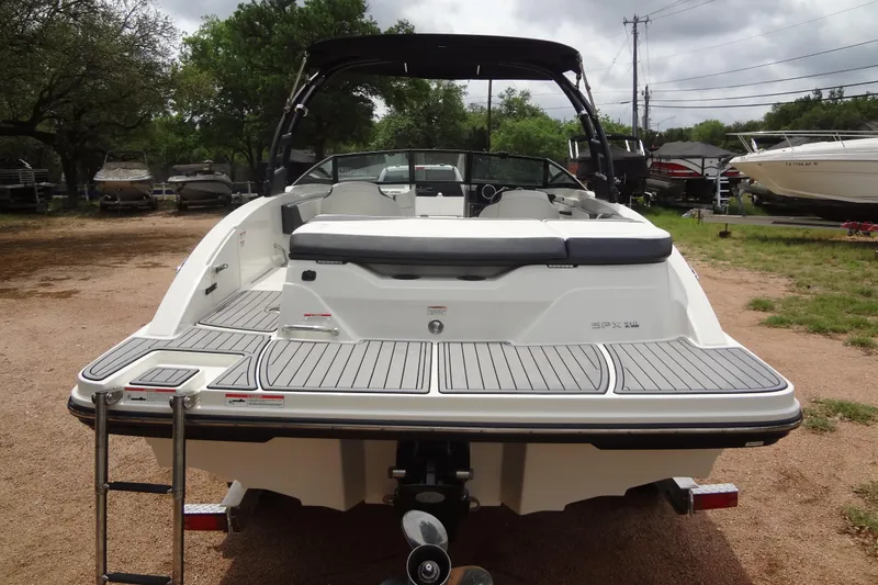 Slide: The Image of 2018 Sea Ray SPX 210 boat with swim platform, parked outdoors. - 3