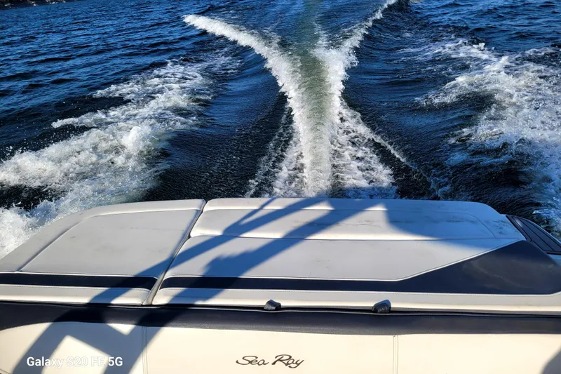 Slide: The Image of 2018 Sea Ray SPX 210 boat cruising on open water, leaving a wake behind. - 37