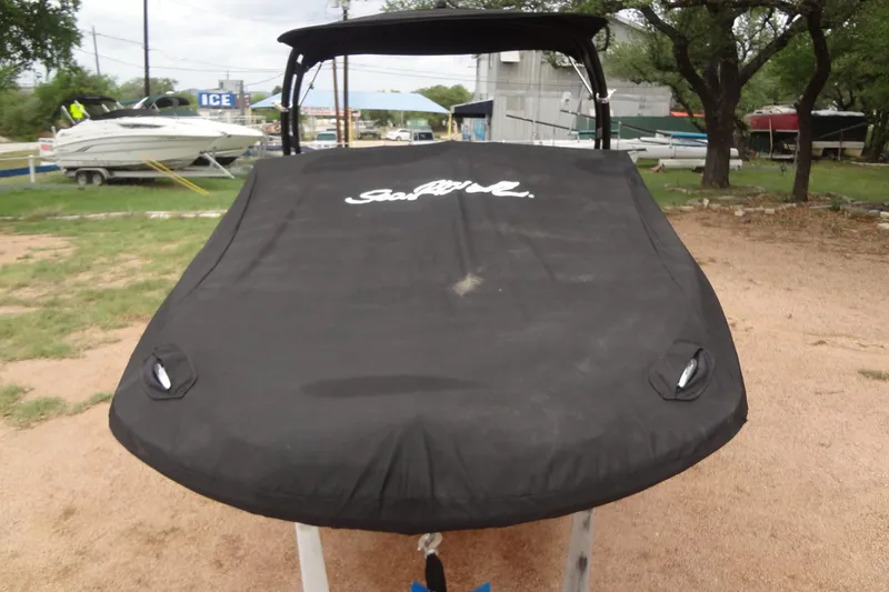 Slide: The Image of 2018 Sea Ray SPX 210 boat with black cover in outdoor setting. - 42