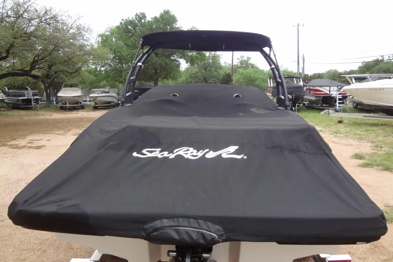 Slide: The Image of Covered Sea Ray SPX 210 boat, 2018 model, in a parking area. - 43