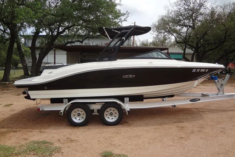 Slide: The Image of 2018 Sea Ray SPX 210 boat on trailer, parked outdoors near trees. - 5