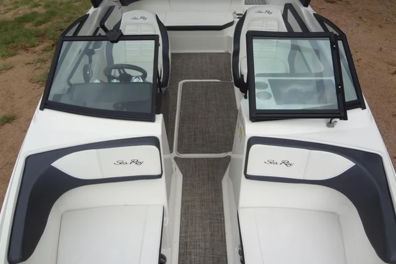 Slide: The Image of 2018 Sea Ray SPX 210 boat interior with dual windshields and seating. - 8